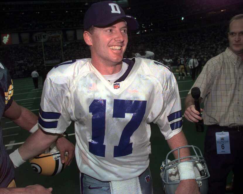 Dallas Cowboys quarterback Jason Garrett smiles as he walks off the field after the Cowboys...