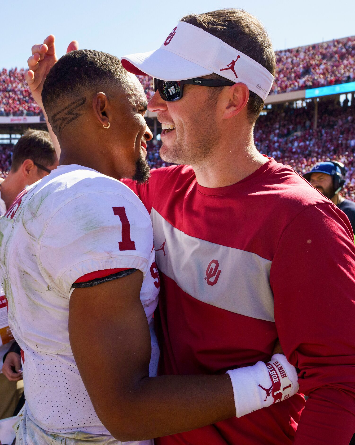 Oklahoma head coach Lincoln Riley hugs quarterback Jalen Hurts after the Sooners victory...