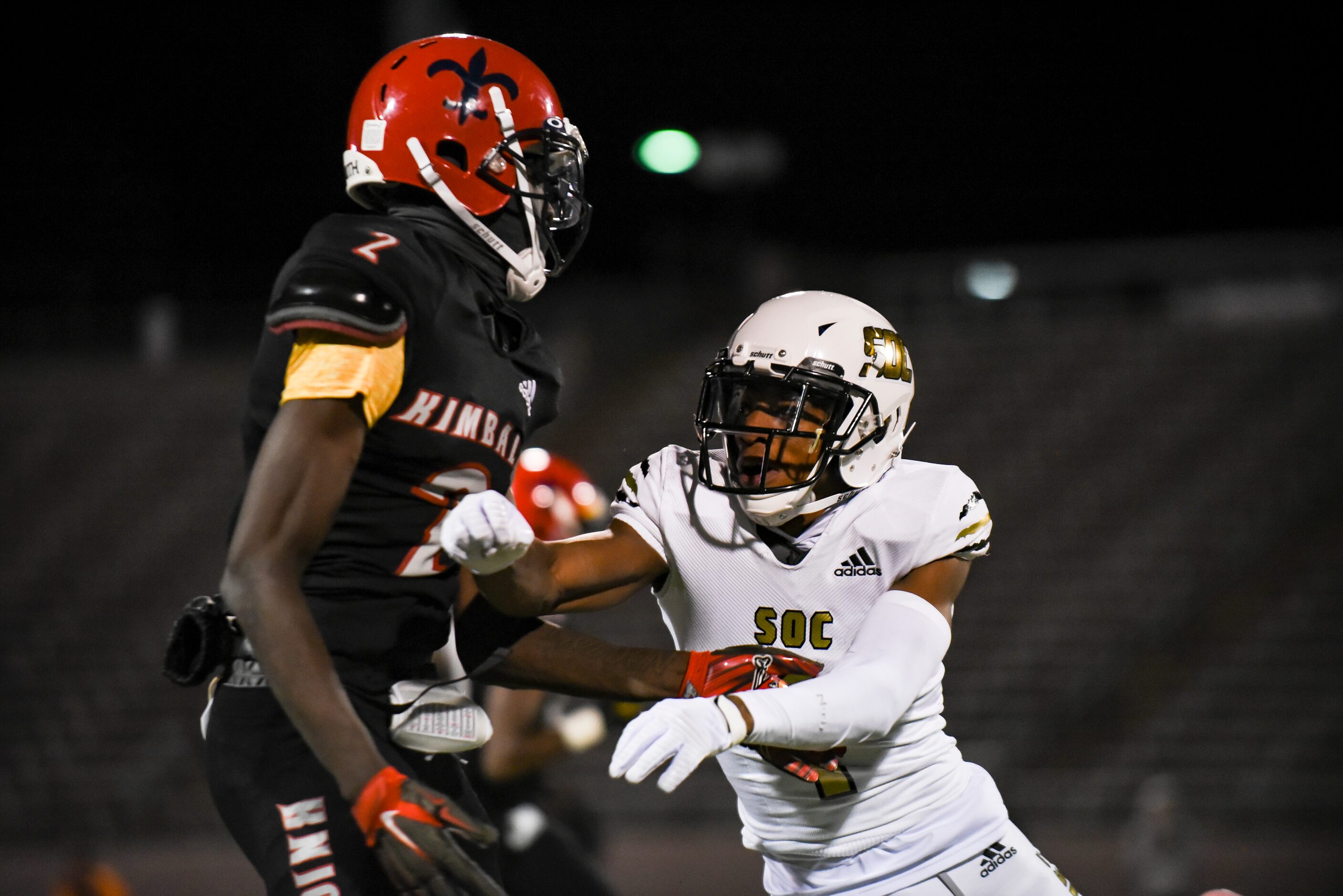 South Oak Cliff junior Manny Muhammad (1) shoves Kimball senior Kyron Henderson (2) during...