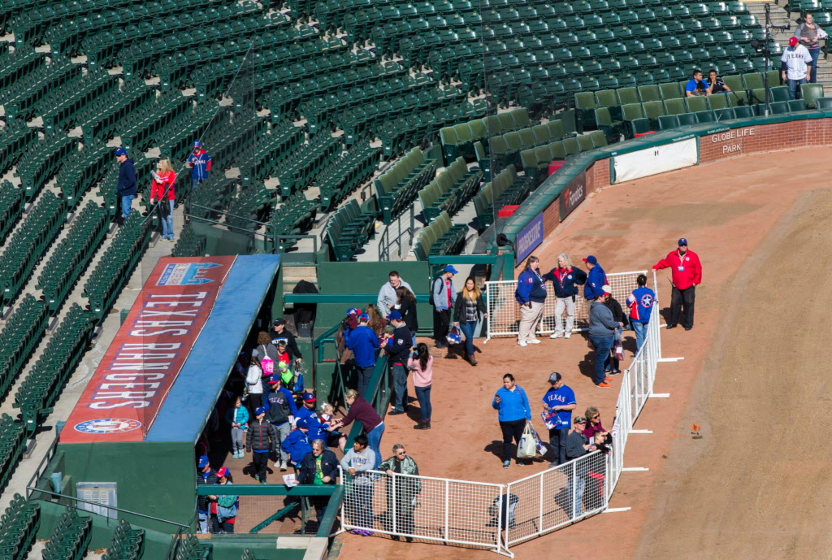 Baseball fans explored the Rangers dugout during Texas Rangers Fan Fest at Globe Life Park...