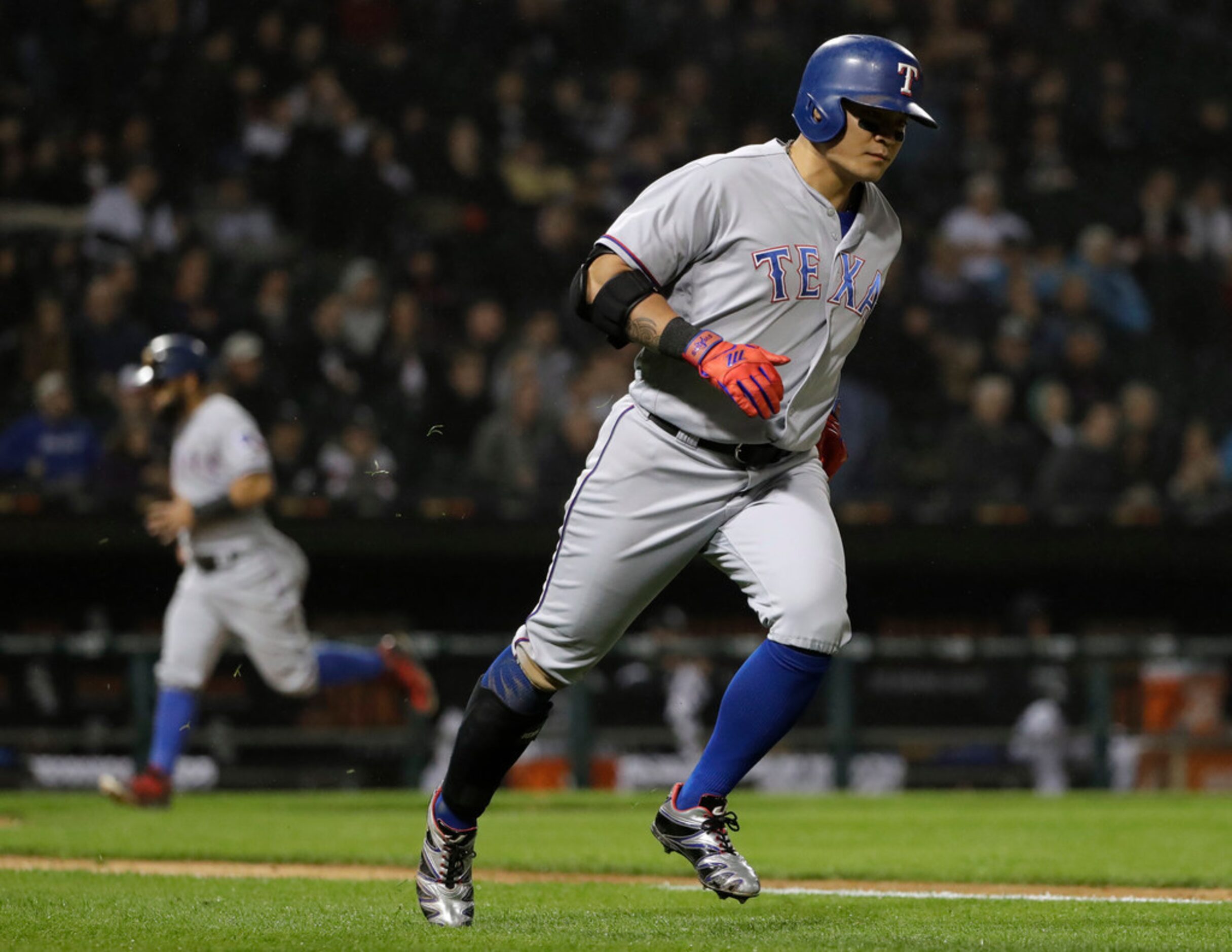 Texas Rangers' Shin-Soo Choo, of South Korea, rounds the bases after hitting a grand slam...