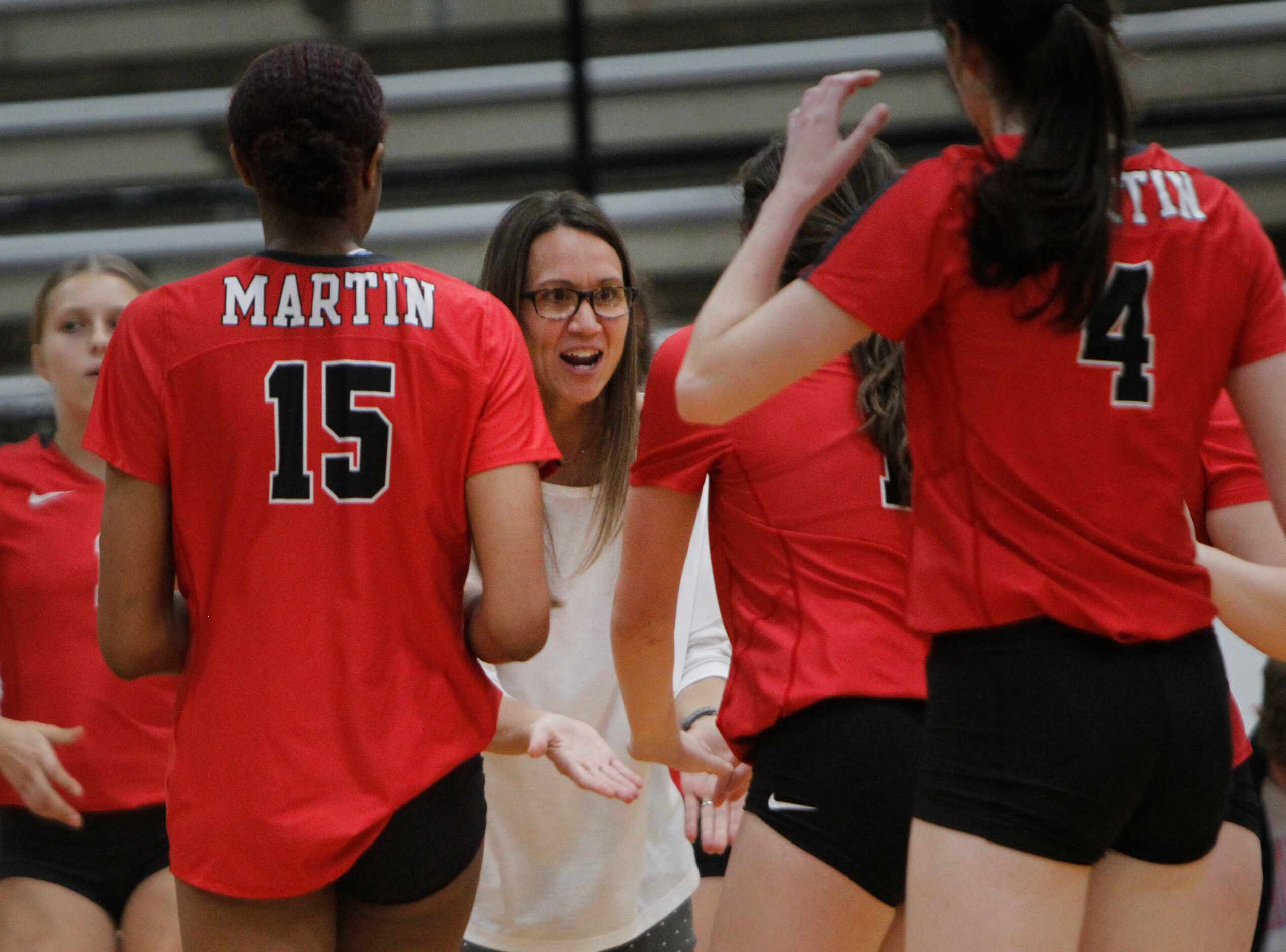 Arlington Martin head coach Rhonda Dunn rests as her players come to the bench after winning...