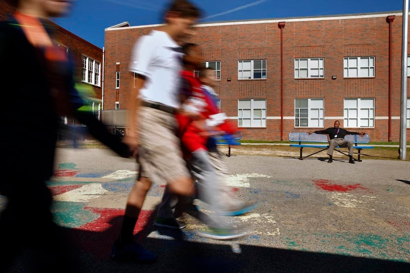 
Randal Hunt watches the sixth-grade Junior ROTC squad do marching drills at J.L. Long...