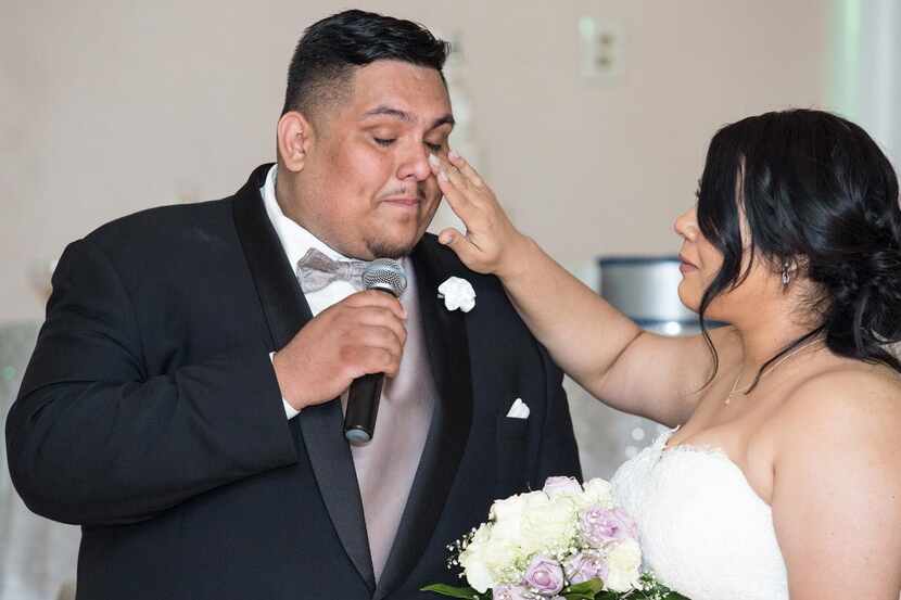 Juanita Sánchez limpia las lágrimas de Félix Sánchez durante su fiesta de boda en noviembre...