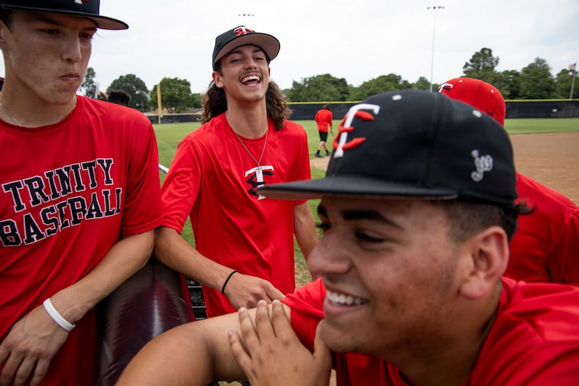 Chase Dickens listens as Luke Crow and Nick Fort share a moment during baseball practice at...