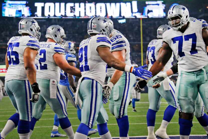 Dallas Cowboys tackle Tyron Smith (77) congratulates Dallas Cowboys running back Ezekiel...