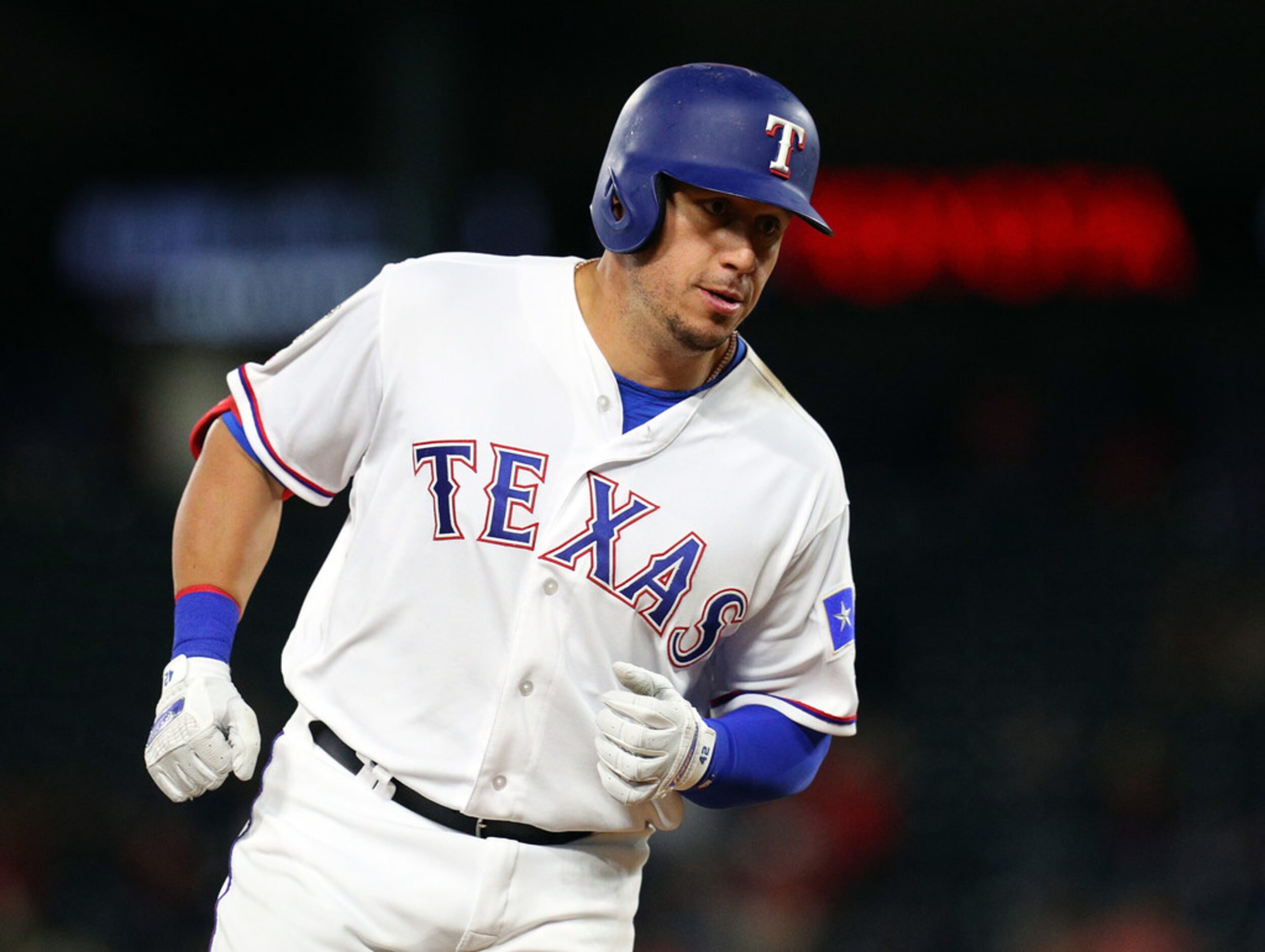 ARLINGTON, TEXAS - APRIL 15: Asdrubal Cabrera #14 of the Texas Rangers rounds third base...