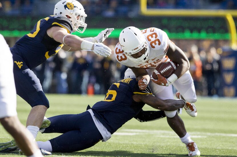 Nov 14, 2015; Morgantown, WV, USA; Texas Longhorns running back D'Onta Foreman is tackled by...