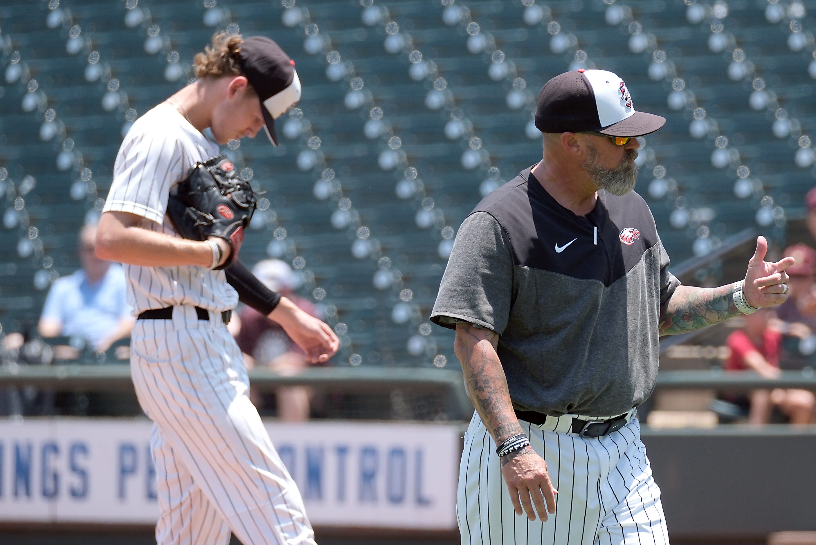 Argyle head coach, Ricky Griffin, gives a thumbs up sign to home plate umpire after checking...