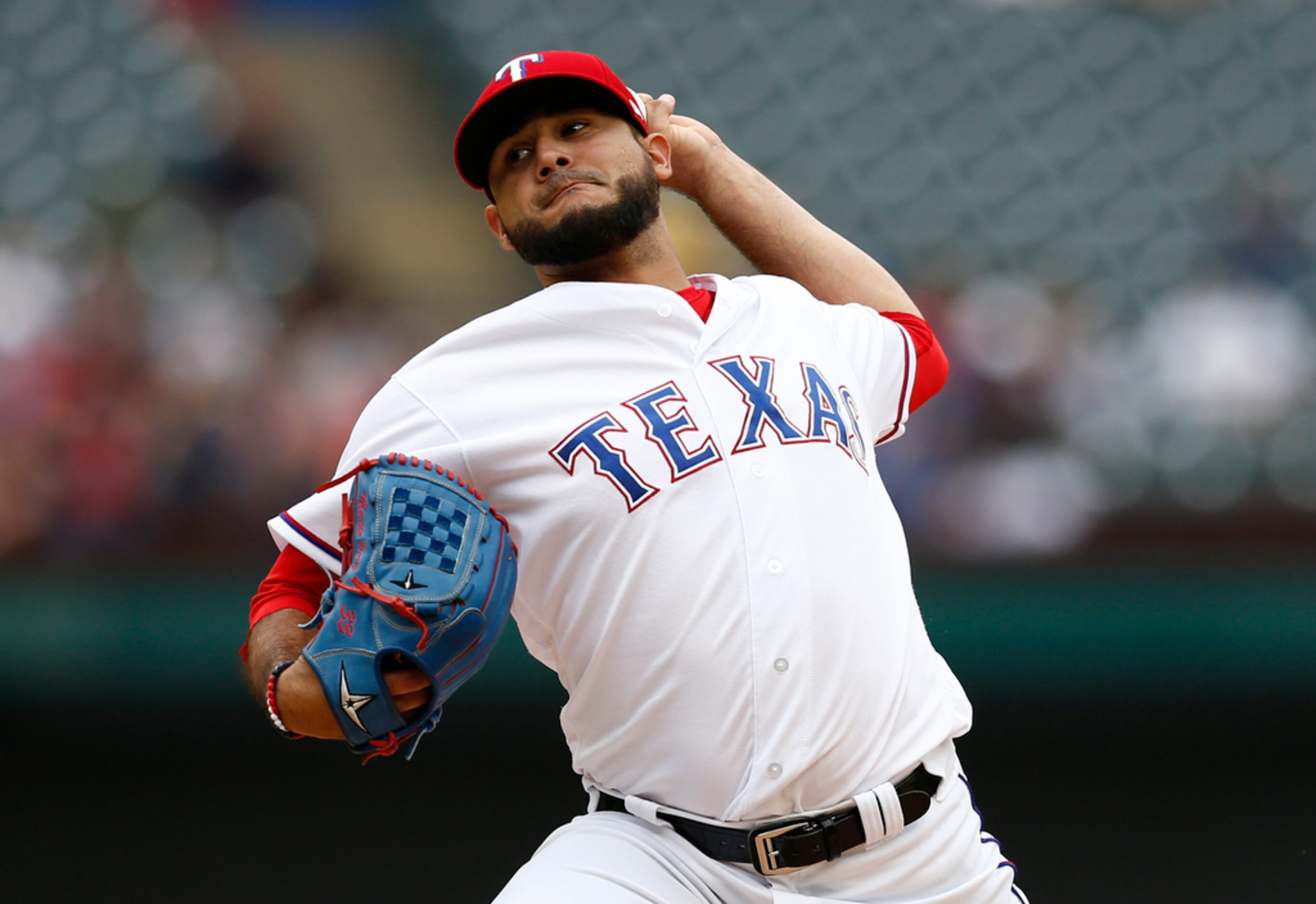 Texas Rangers starting pitcher Martin Perez delivers to a Seattle Mariners batter during the...