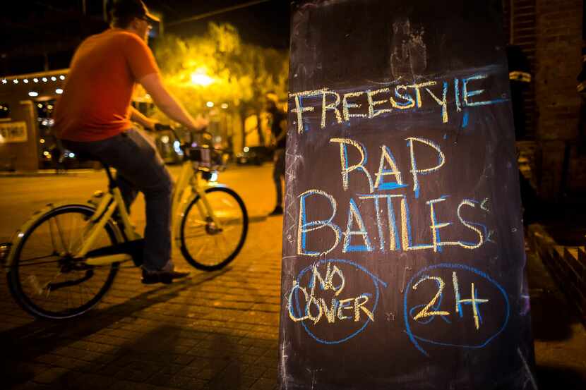 A chalkboard on the sidewalk advertises the weekly hip-hop night at Independent Bar and...