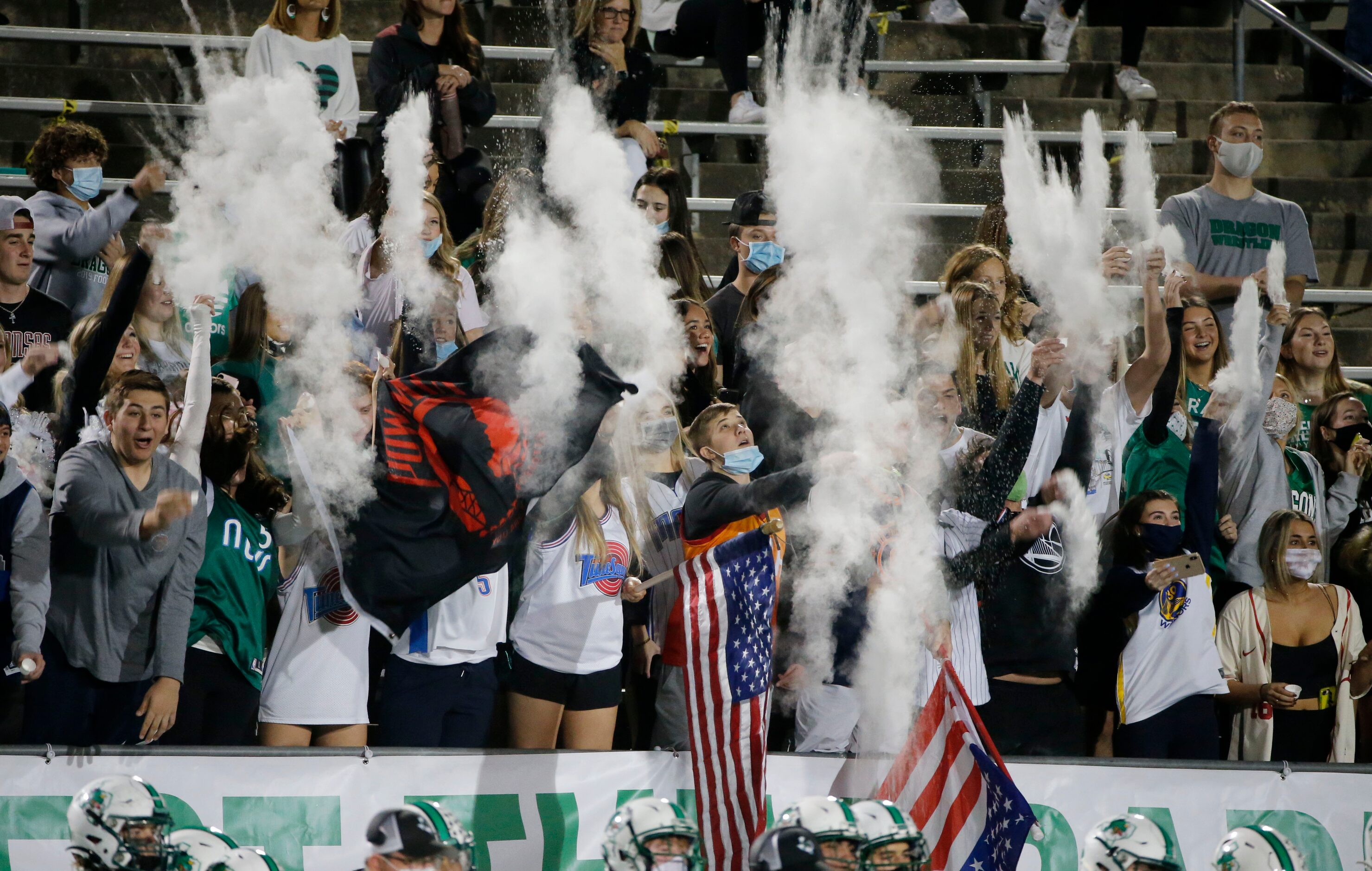 Southlake students throw powder as the team kicks off against Eaton, during their high...