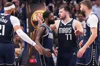 Dallas Mavericks guard Luka Doncic (77) celebrates with guard Kyrie Irving (11) during the...