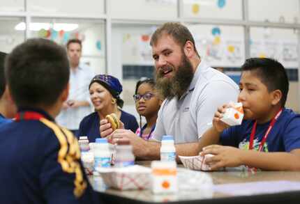 FILE - Travis Frederick eats breakfast with fifth-grade students as part of the launching of...