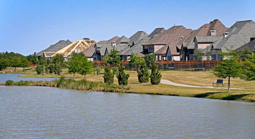 Houses are seen near a lake in the Light Farms community in Celina.