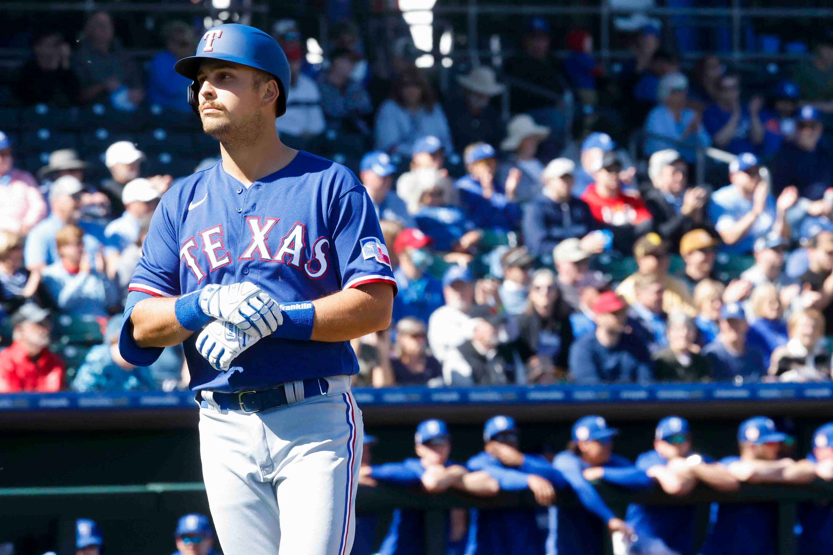 Texas Rangers infielder Nathaniel Lowe head to the dugout after a pop fly out during the...