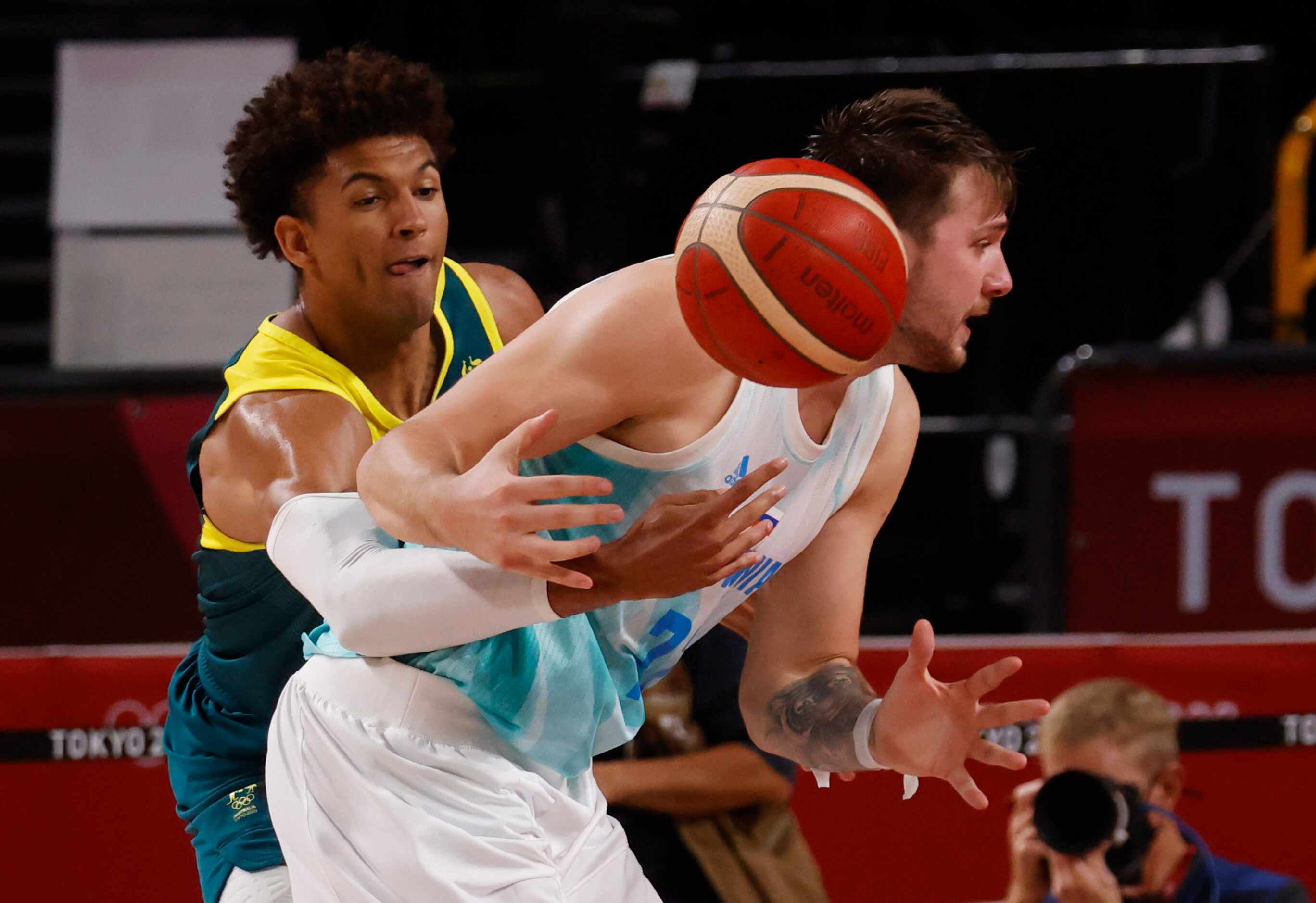 Australia’s Matisse Thybulle (10) knocks the ball out of the hands of Slovenia’s Luka Doncic...