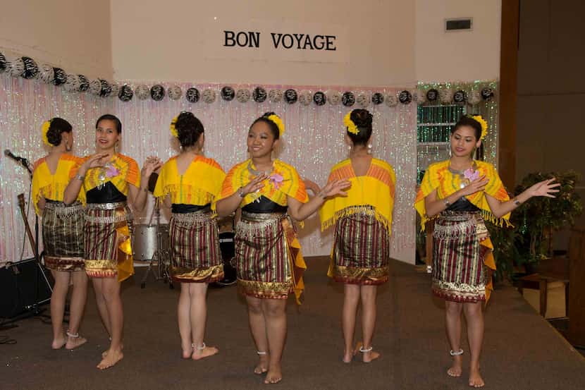  Dancers perform at a goodbye party for  Asman Nasution at Holy Family in Irving.  (Photo by...