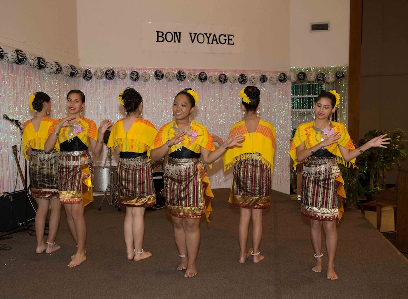  Dancers perform at a goodbye party for  Asman Nasution at Holy Family in Irving.  (Photo by...