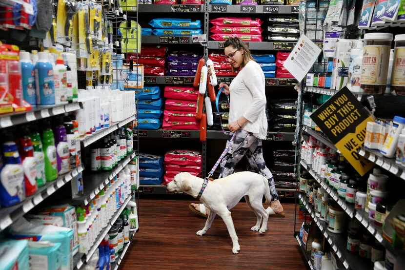 Mackenzie Capetillo, of Dallas, walks toward the back of the store to bathe her dog, Zoey,...