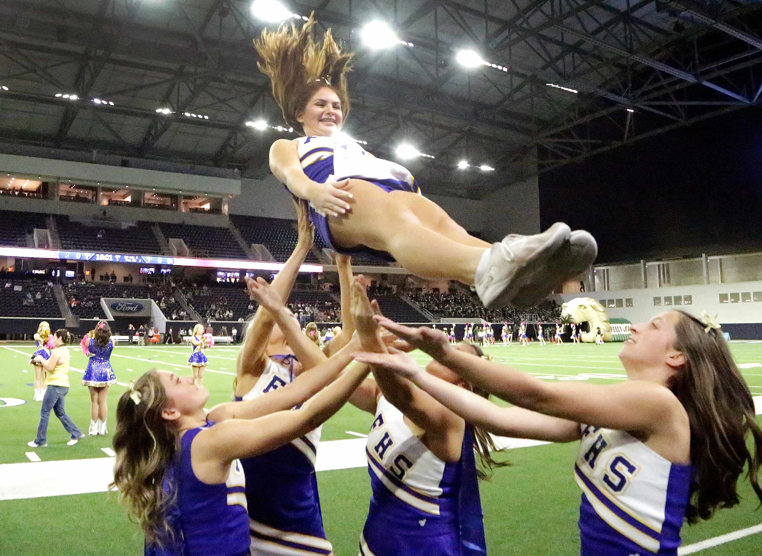 Frisco High School cheerleader Rocki Cook, 17, falls back into the hands of her fellow...