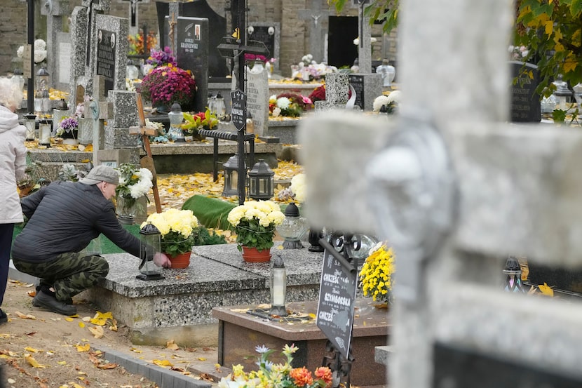 People prepare for All Saints' Day at the cemetery in Zakroczym, near Warsaw, Poland,...