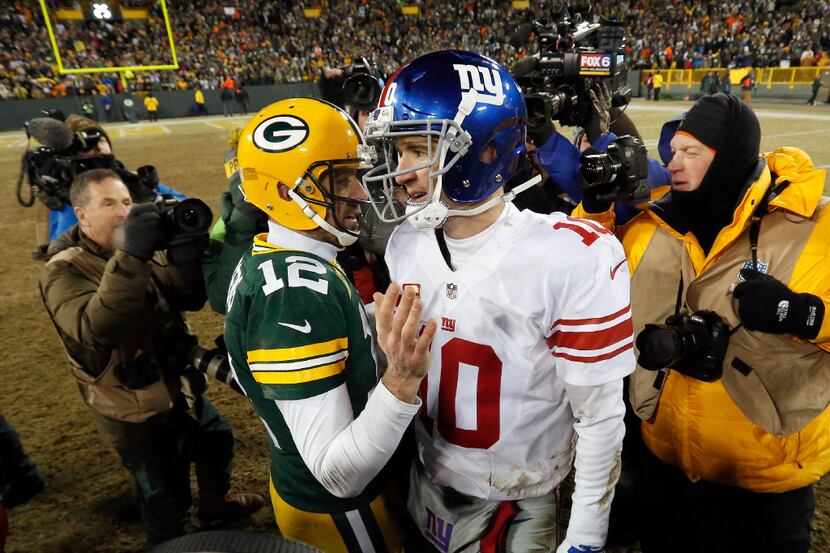 Green Bay Packers quarterback Aaron Rodgers (12) and New York Giants quarterback Eli Manning...