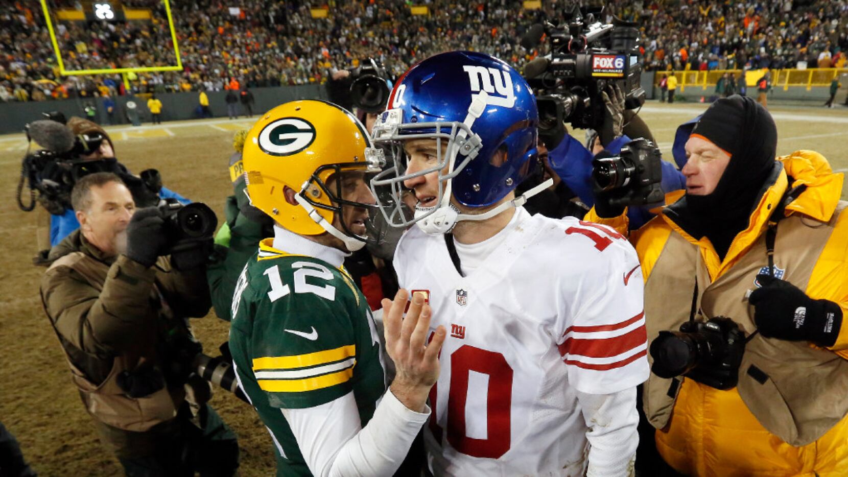 Green Bay Packers quarterback Aaron Rodgers (12) and New York Giants quarterback Eli Manning...