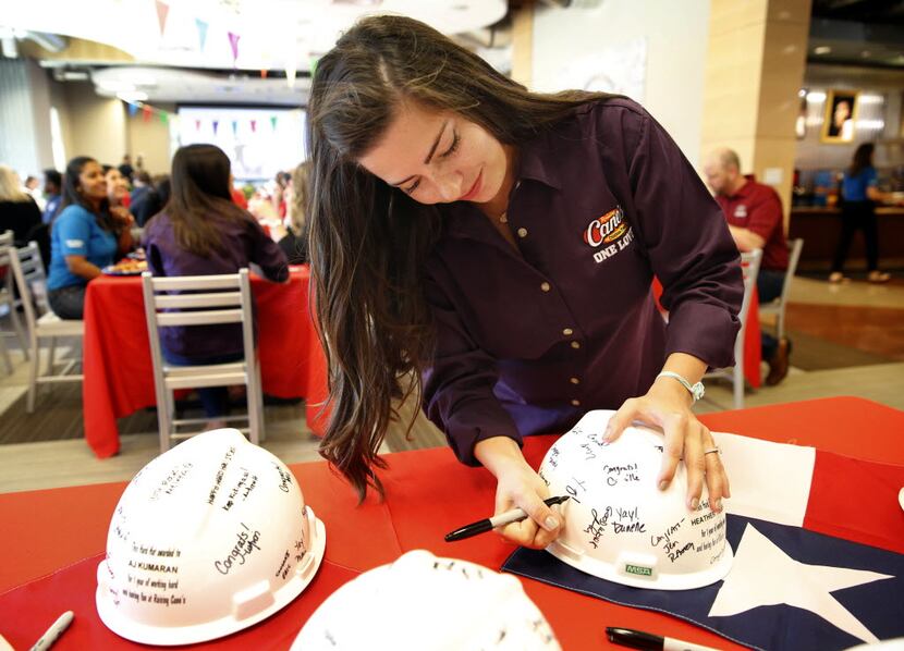Raising Cane's marketing advisor/New Orleans Erin Credo signs construction helmets for first...