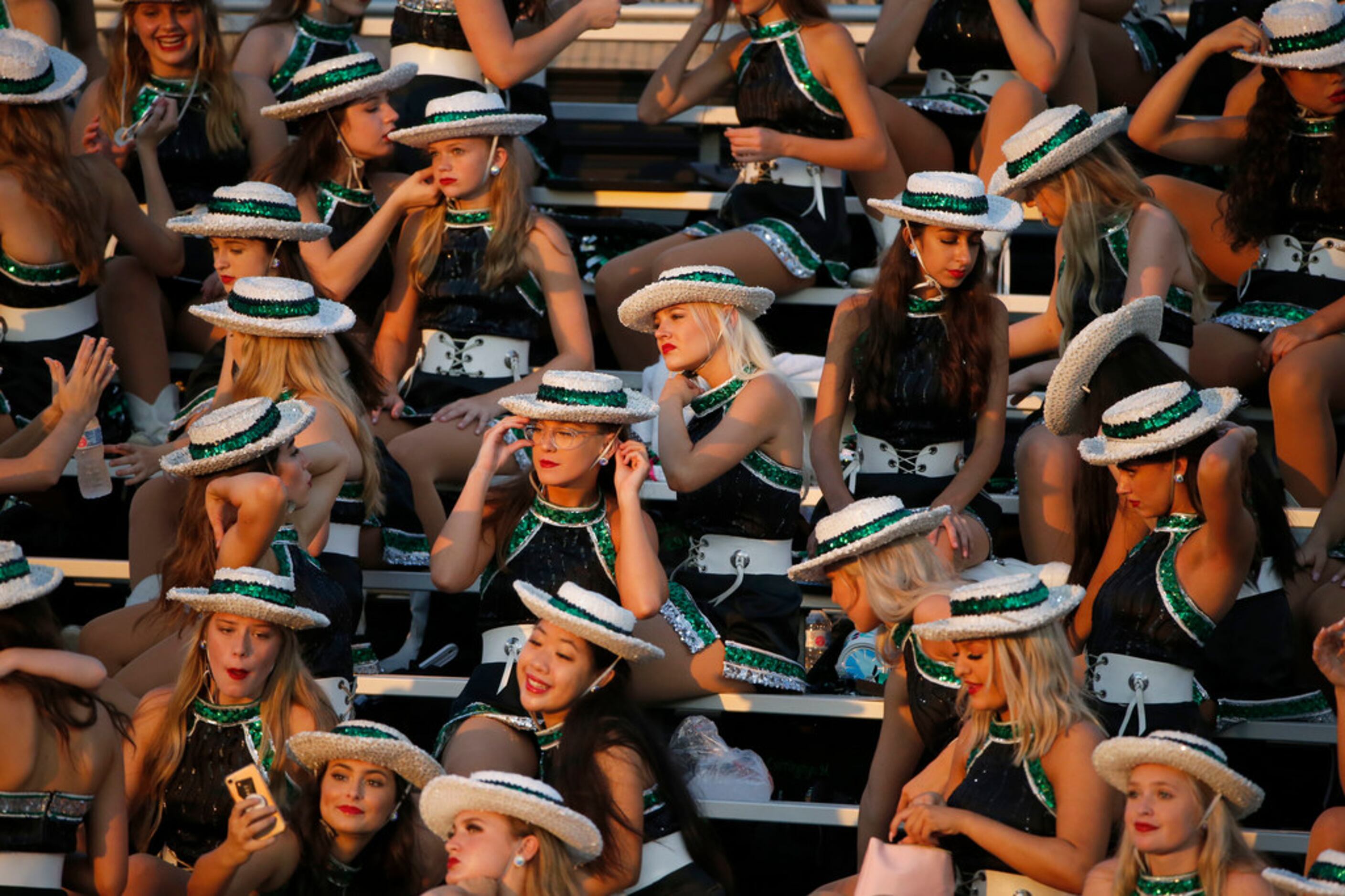 Southlake Emerald Belles drill team members prepare for their halftime performance their...