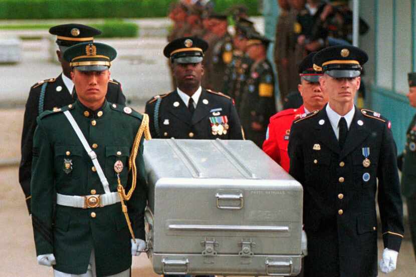 In this May 14, 1999, file photo, U.N. honor guards carry a coffin containing the remains of...