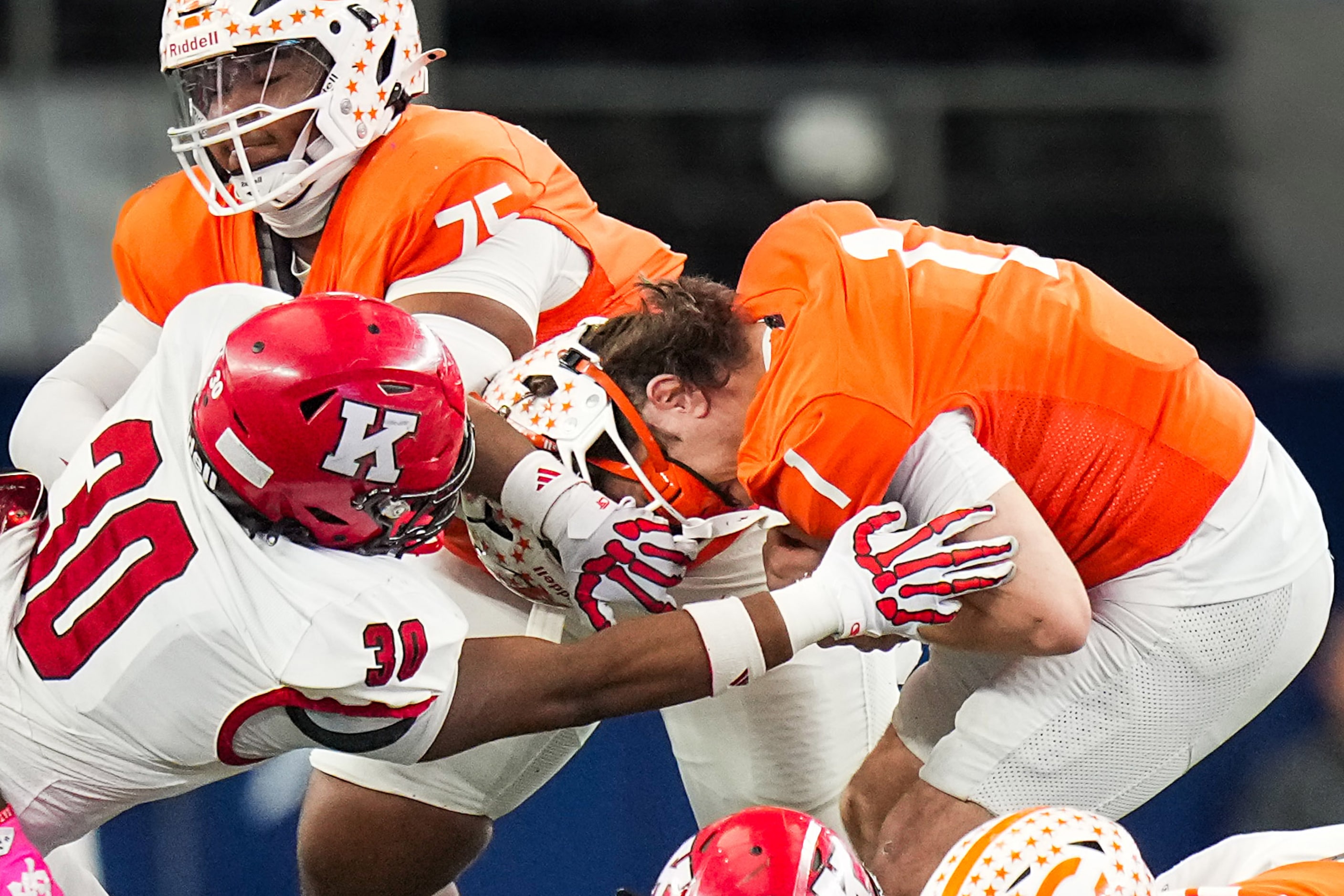 Kilgore's Wylie Mitchell (30) pulls off Celina quarterback  Bowe Bentley’s face mask during...