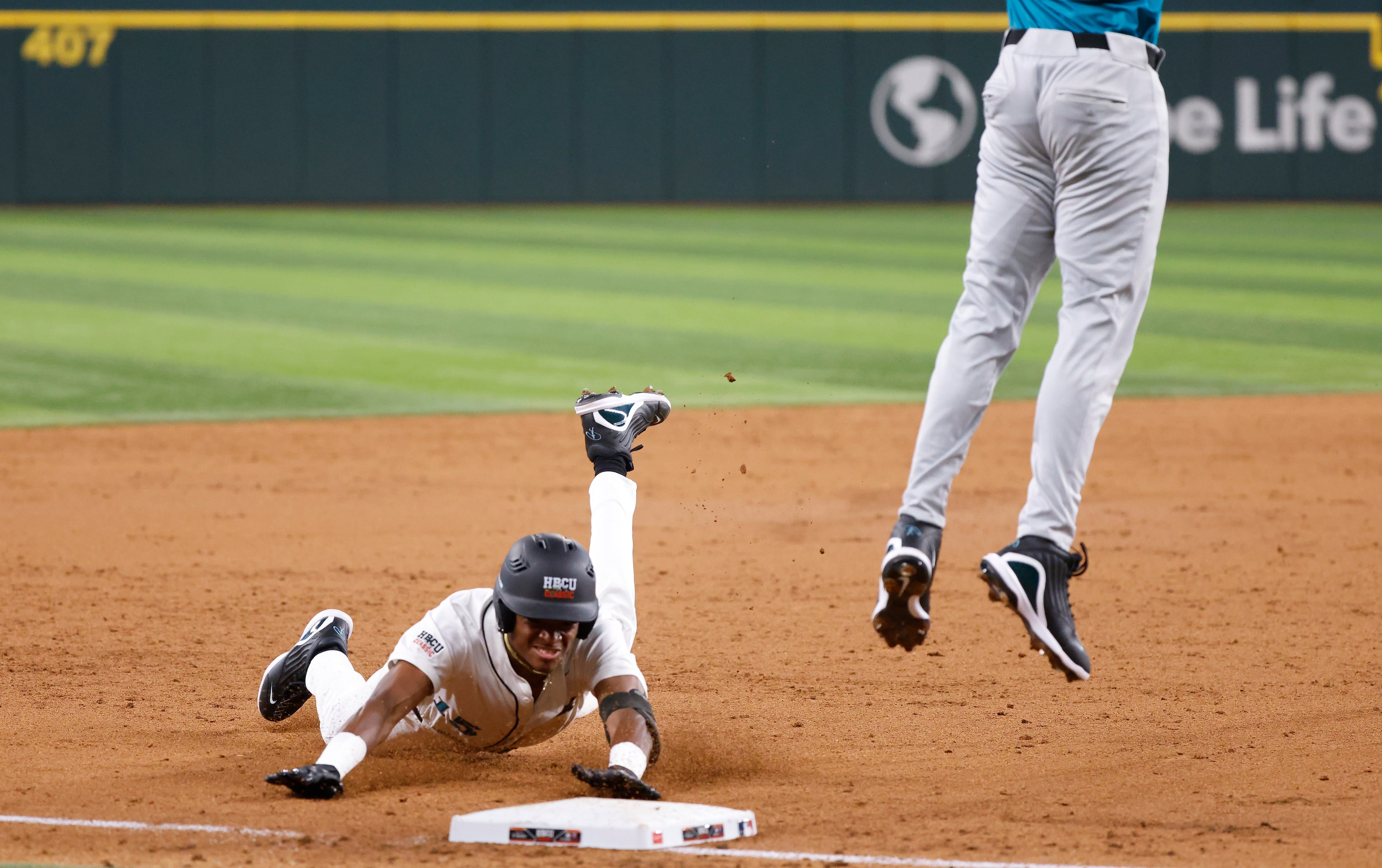 American League batter Robert Tate Jr. slides safely into third base on a triple during the...