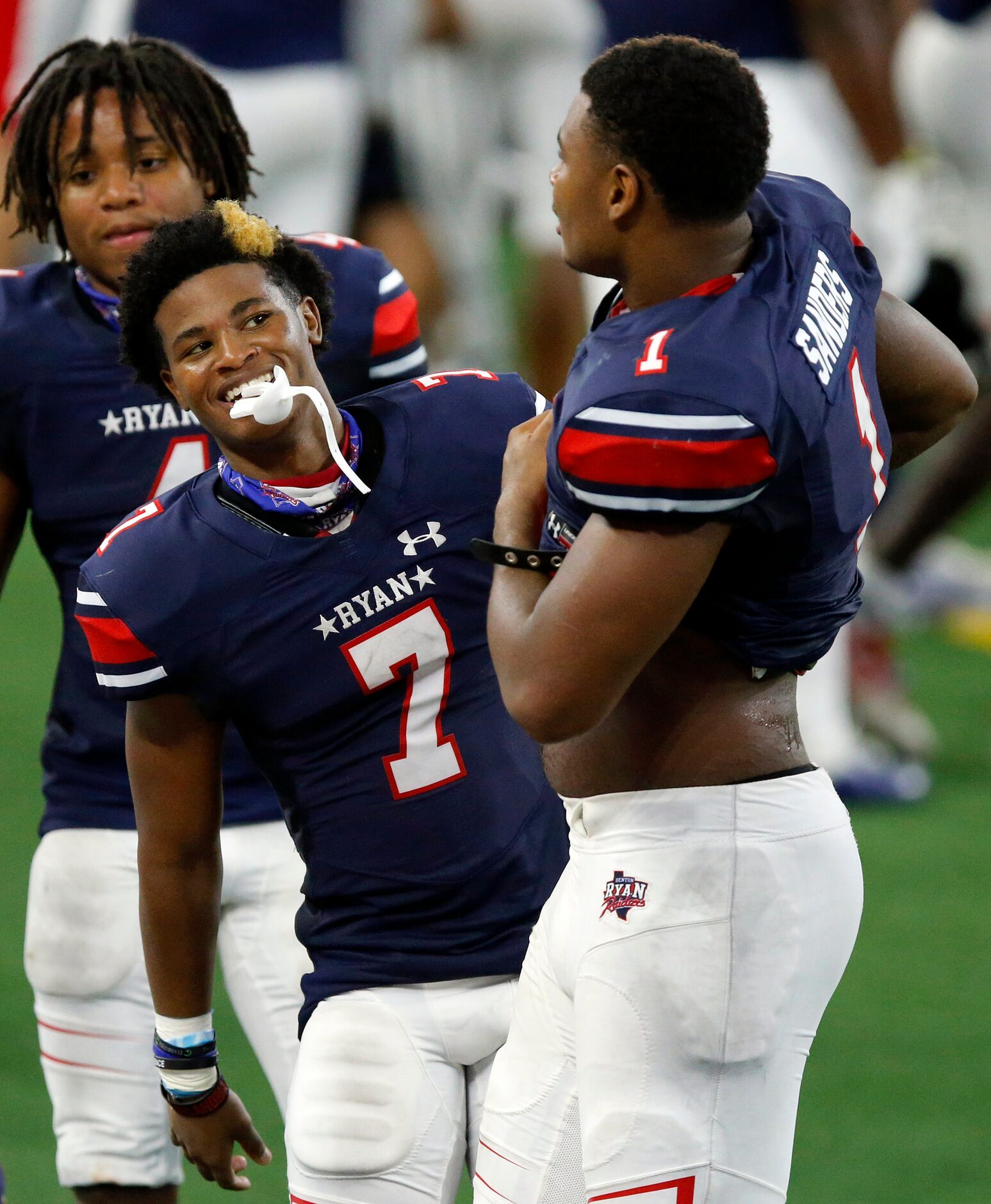 Denton Ryan cornerback Garyreon Robinson (7) jokes with receiver Ja'Tavion Sanders (1) as...