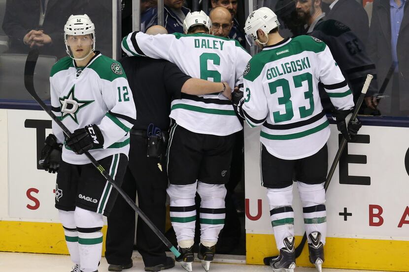 Dec 5, 2013; Toronto, Ontario, CAN; Dallas Stars Trevor Daley (6) is escorted off the ice...