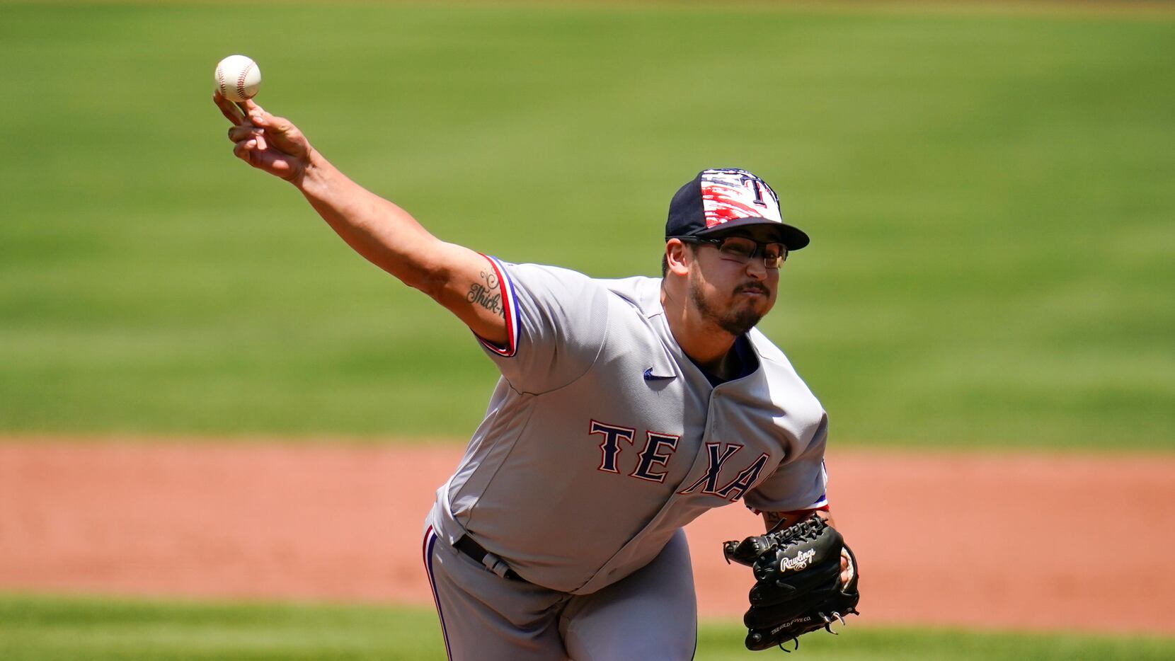 Texas Rangers starting pitcher Dane Dunning throws a pitch to the Baltimore Orioles during...