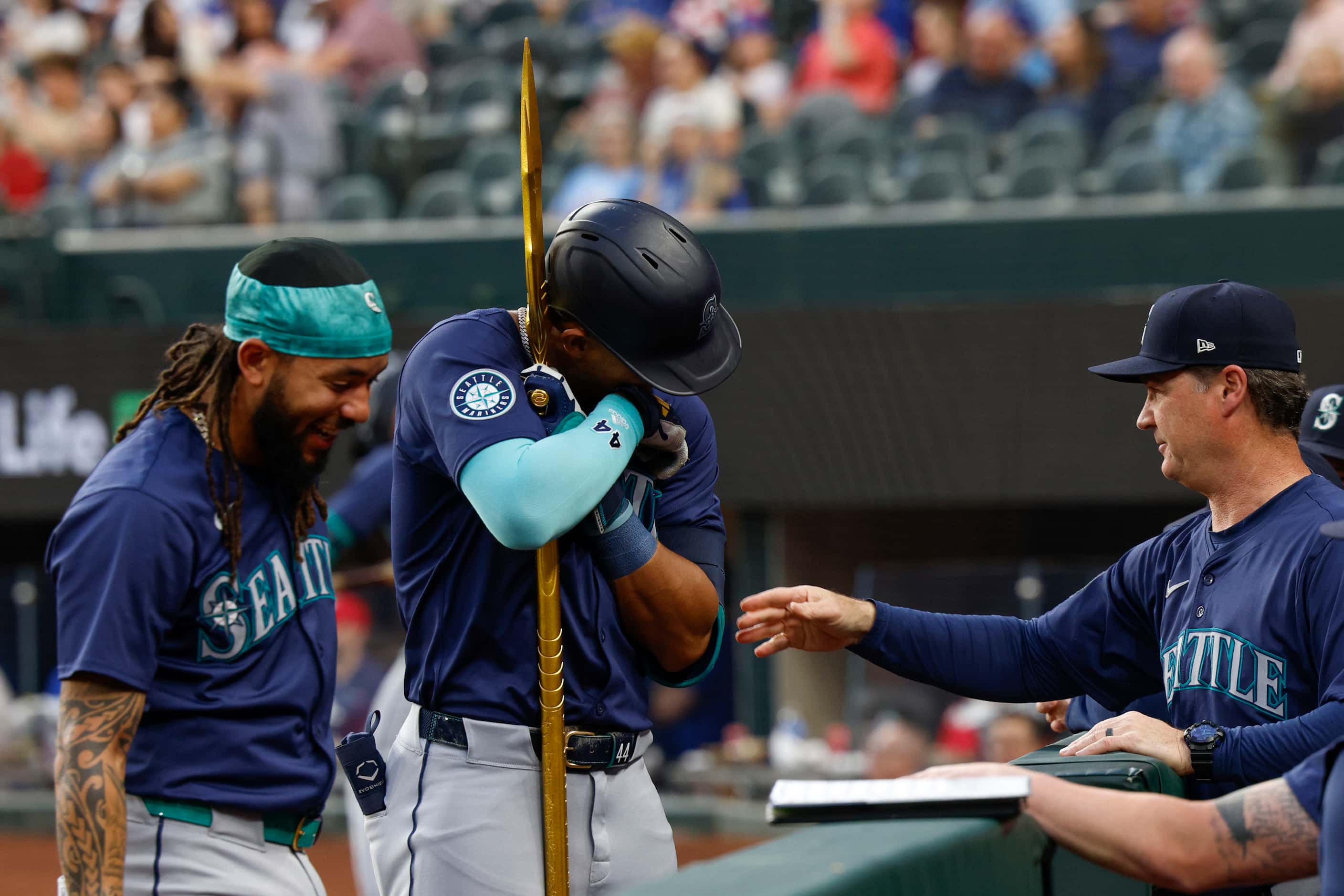 Seattle Mariners center fielder Julio Rodriguez (44) hugs a trident as he celebrates his...