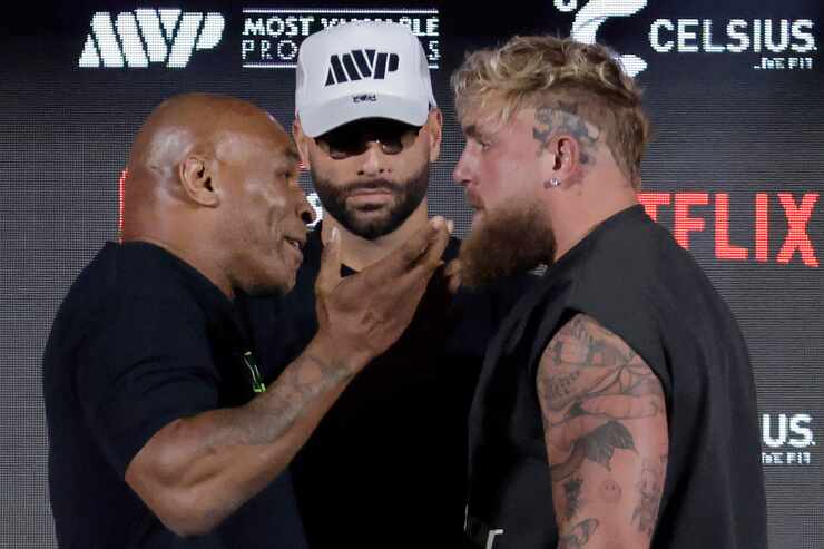 Ahead of their July fight at AT&T Stadium, boxers Mike Tyson (left) reacts to the advances...