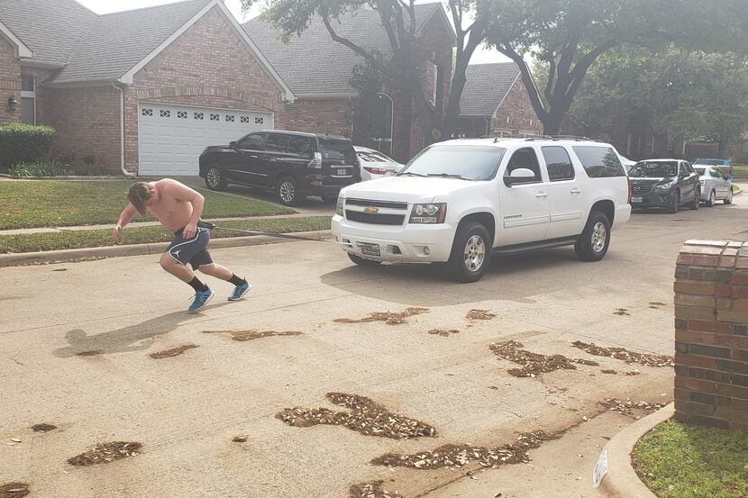 Flower Mound defensive tackle Colton Vatne pulls his mother's Suburban as a form of strength...