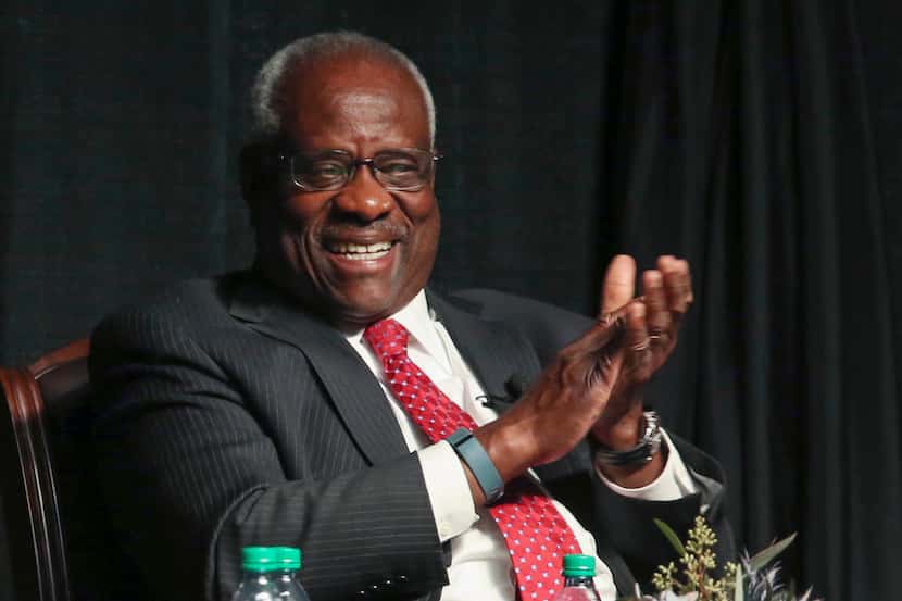 Supreme Court Justice Clarence Thomas laughs before speaking at McLennan Community College...