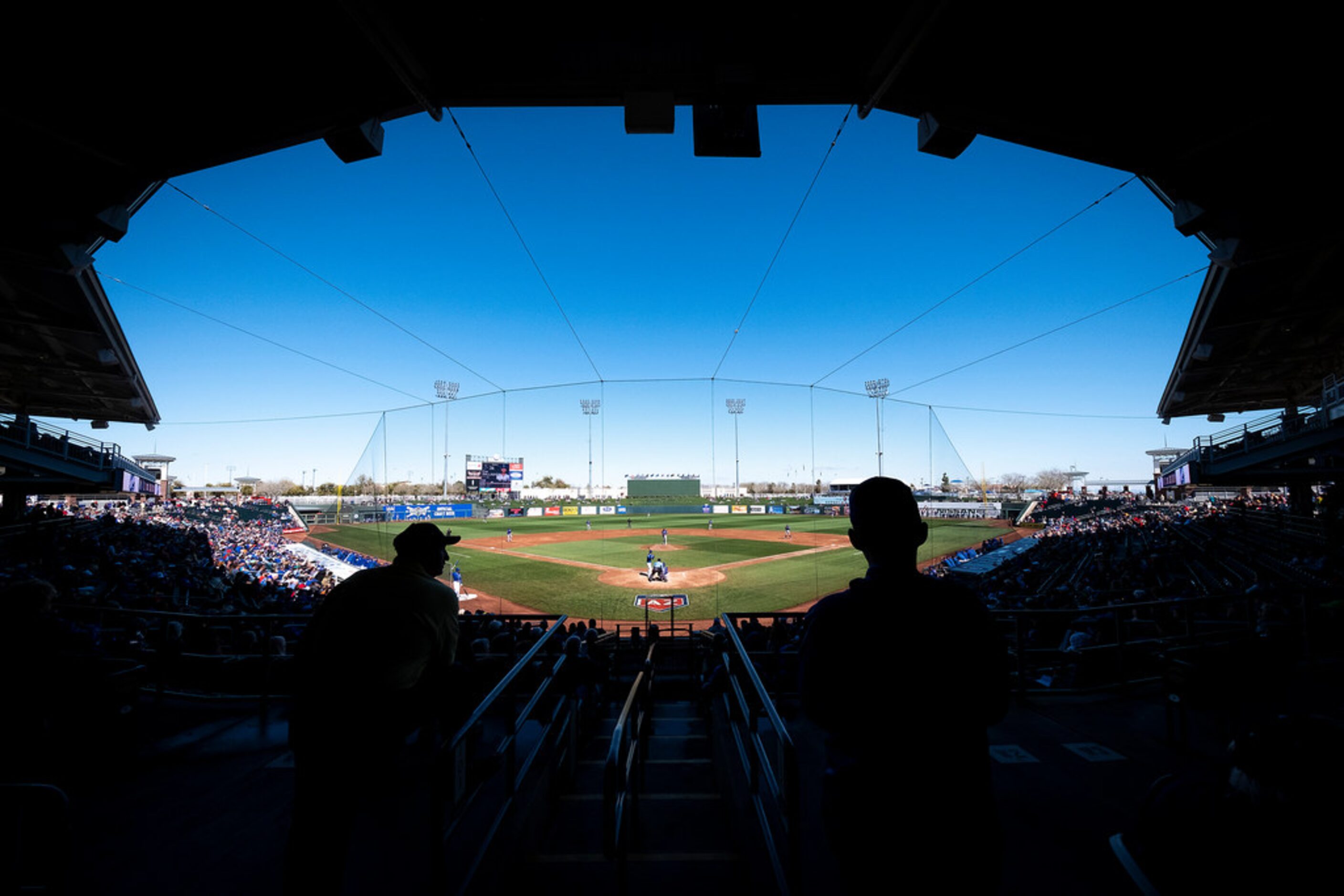 Fans watch the Kansas City Royals bat against the Texas Rangers during the second inning of...