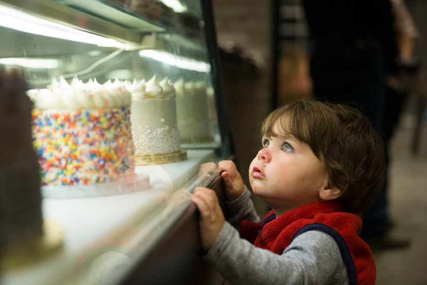 Jackson Miles of Fort Worth, 1, eyes pastries at Gigi's Cupcakes at the Food Hall at...