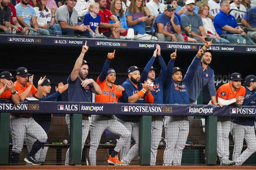 Houston Astros payers celebrate in the dugout after a double by Jose Altuve during the first...