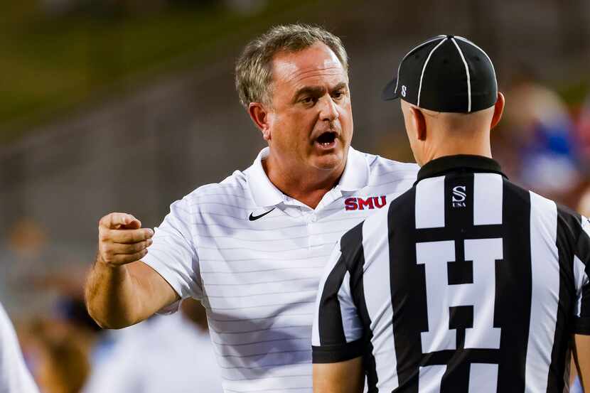 SMU head coach Sonny Dykes talks to refs as they review Southern Methodist Mustangs running...