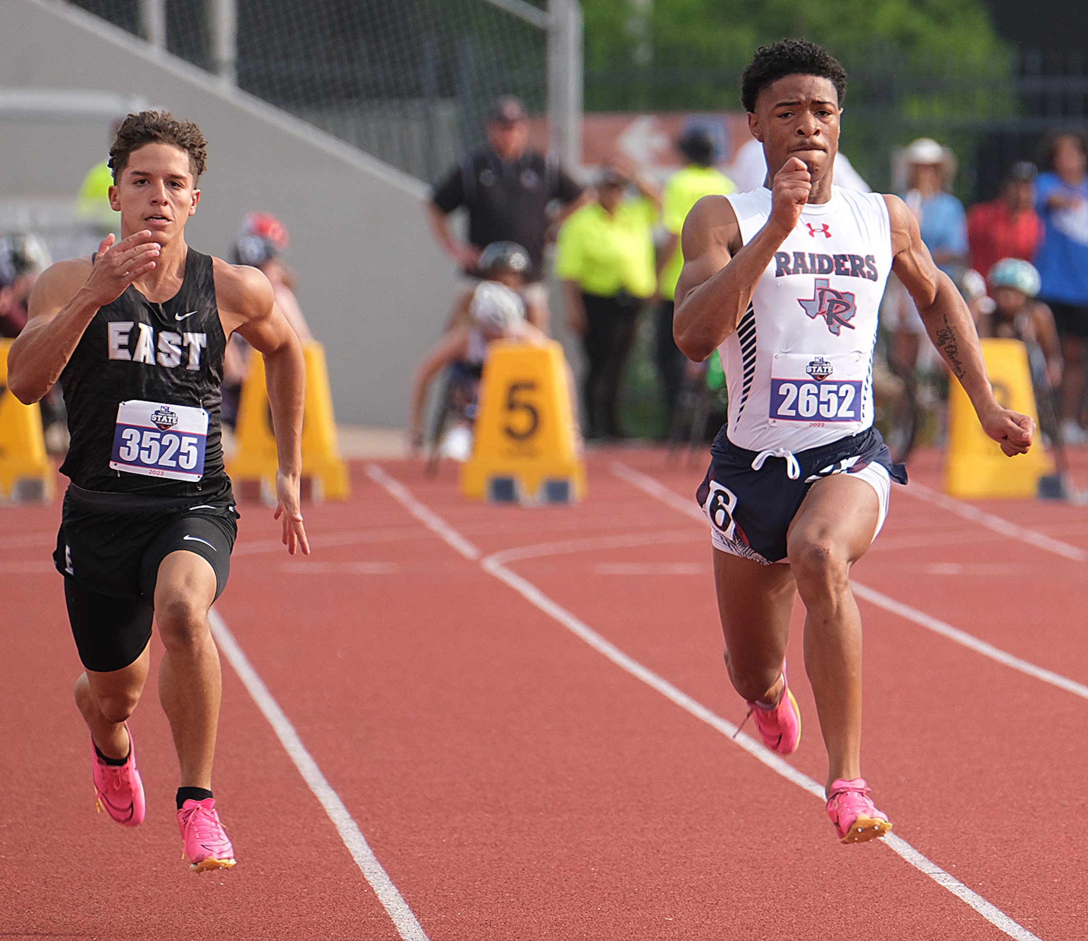 Josiyah Taylor of Denton Ryan races Gael Romo of Weslaco East in the boys 100 M dash at the...