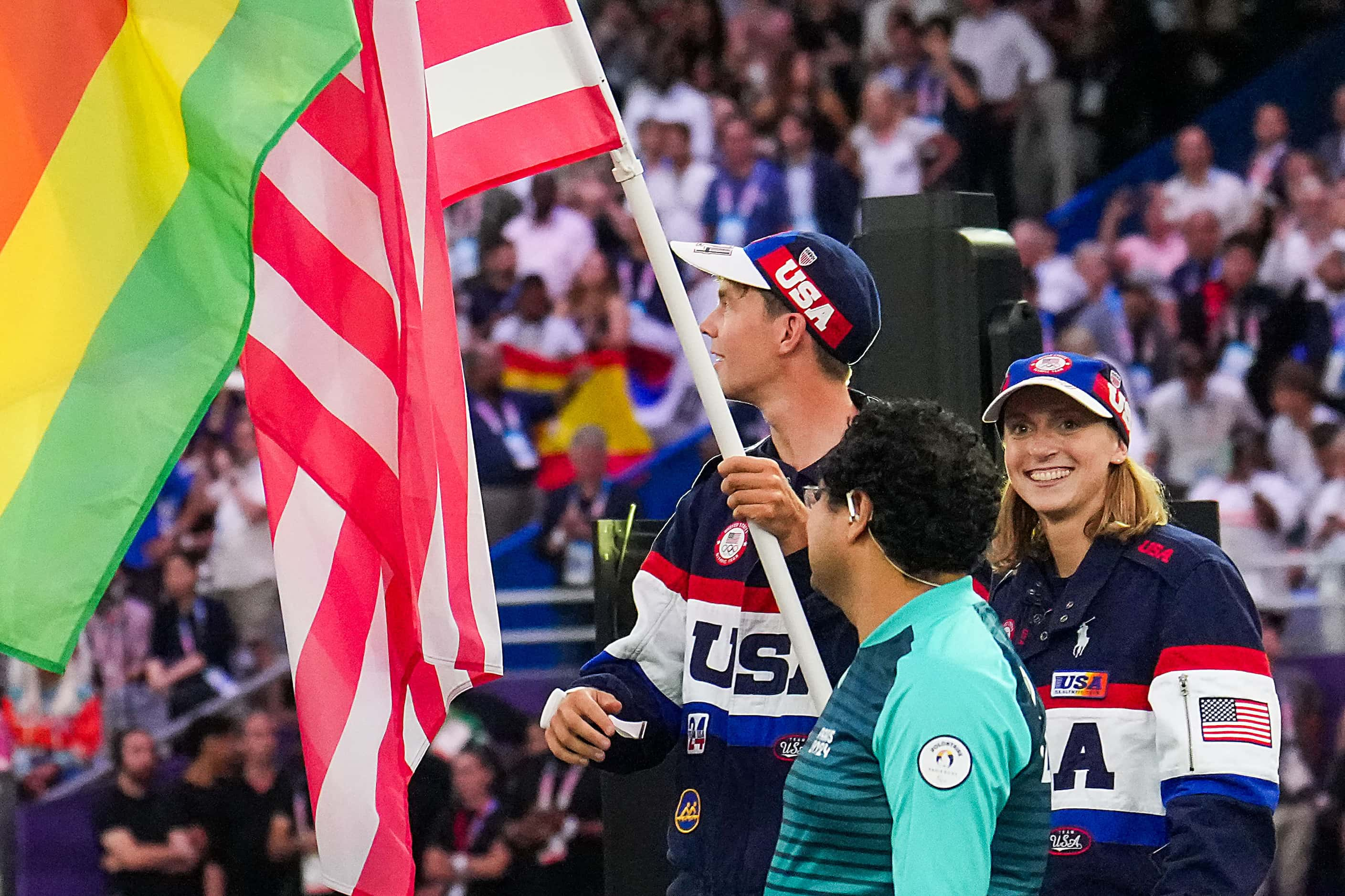 Flag bearers Nick Mead and Katie Ledecky carry the stars and stripes for the United States...