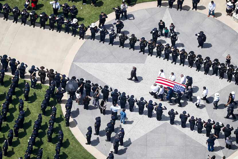 The casket of slain Dallas police officer Patrick Zamarripa was carried by an honor guard...