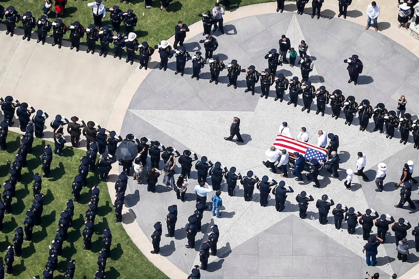 The casket of slain Dallas police officer Patrick Zamarripa was carried by an honor guard...