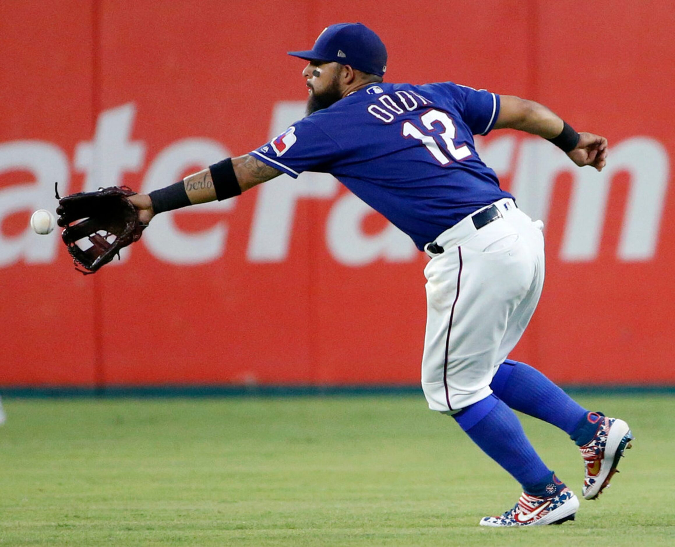 Texas Rangers second baseman Rougned Odor (12) can't reach a line drive single by Houston...