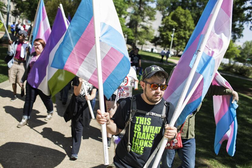 Zachary Anders of Asheville, N.C., marches to the North Carolina Capitol in protest of the...